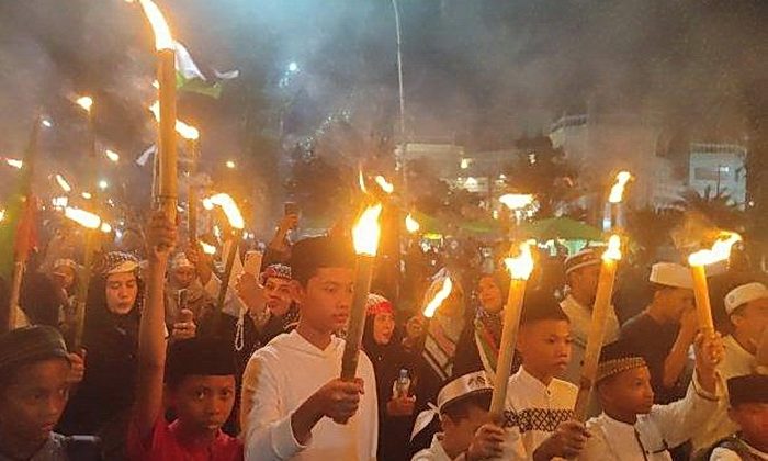 Warga di Kota Medan mengikuti pawai obor dalam rangka menyambut datangnya Bulan Suci Ramadan 1445 H, Jumat (8/3/2024).